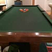 8 foot slate pool table. Like new condition. Dark wood with leather pockets. Dark green felt.